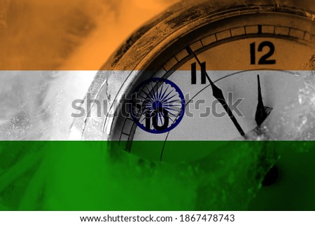 India flag with clock close to midnight in the background. Happy New Year concept