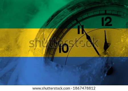 Gabon, Gabonese, Gabonian flag with clock close to midnight in the background. Happy New Year concept