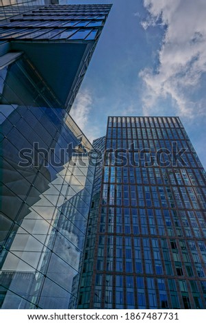 New York, New York: Abstract patterns formed by the reflections of buildings  in the glass facade of a modern office building.
