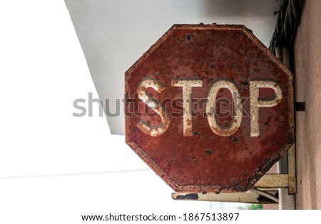 A old stop sign in red and white