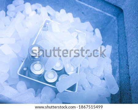 Closeup on vials with crimp caps placed on dry ice prepared for medical transport. Selected focus. Royalty-Free Stock Photo #1867515499