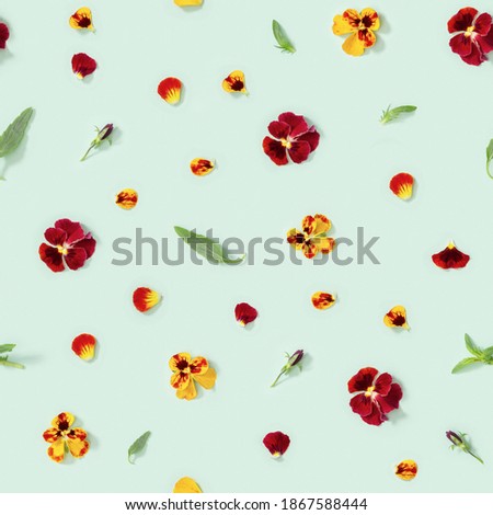 Seamless pattern with natural blossom flowers pansy, buds, fresh leaves, petals on light green paper. Small bright blooms.