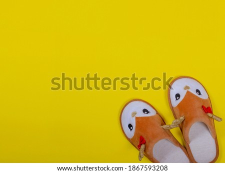 Home slippers in the form of a Christmas deer on a yellow background. Christmas and New Year concept. Stay at home. Postcard. Copy space. Flat lay