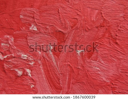     chaotic paint strokes. Stained red and white color painted wall surface . rough plaster texture. sloppy bumpy staining, Grunge textured background with copy space               