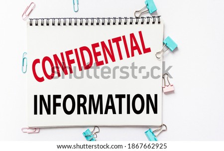 Confidential information text on notepad and white background with stationery