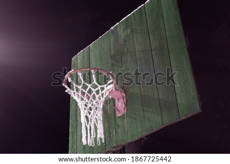Basketball net covered with frost at night