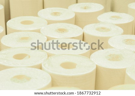Selling rolls of paper wallpaper in the store.