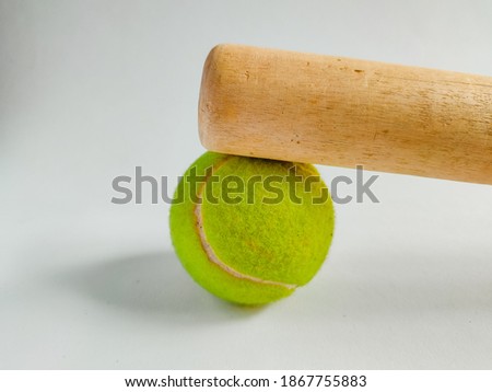 tennis ball with a baseball bat 