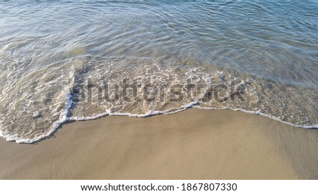 Wave of blue sea on sandy beach 