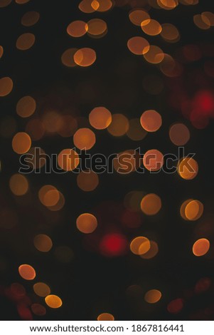 simple Christmas background pattern vertical picture golden dark lights from garland lamp