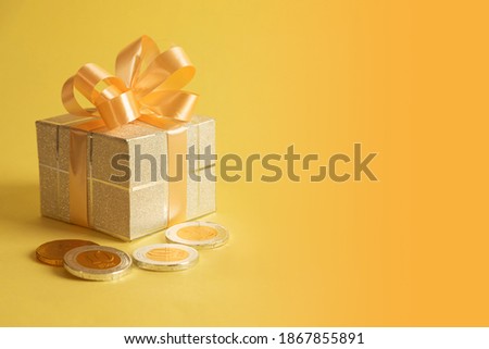 Image of jewish holiday Hanukkah with gift box, chocolate coins.