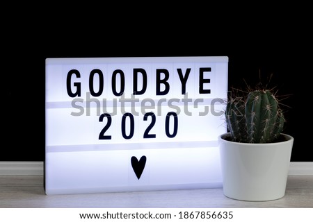 Farewell to a bad year 2020. Lightbox with goodbye message and potted cactus. Royalty-Free Stock Photo #1867856635