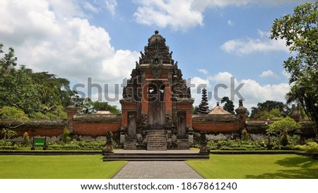 Taman Ayun Temple the Royal Family Temple in Mengwi, huge state temple of Mengwi Kingdom surrounded by a wide moat, the temple built in 1634. Outside yard with open grassy expanse and meeting hall for