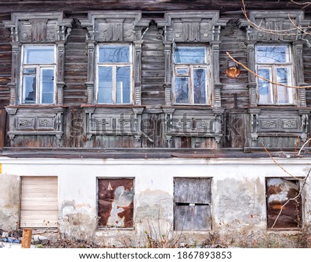 Facade of old abandoned  traditional house 19th century. Stone ground floor, wooden upper floor. Front view