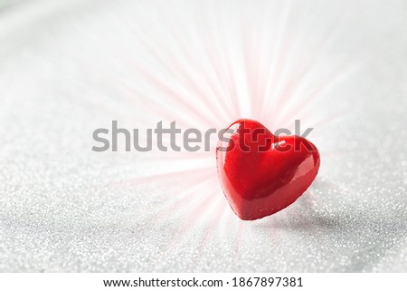 Valentines day background with red heart over abstract silver background
