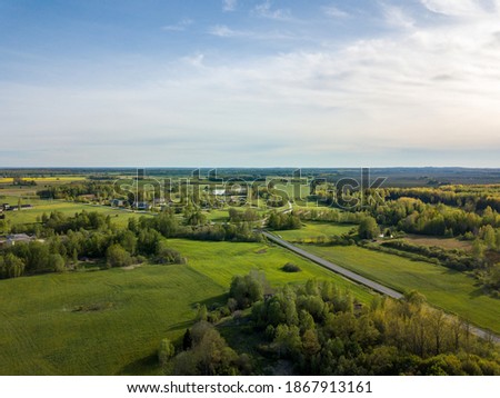 summer fields forests and roads in countryside view from above drone image with nice sky and clouds