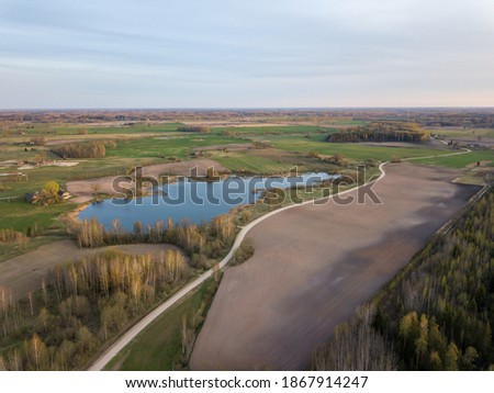 summer fields forests and roads in countryside view from above drone image with nice sky and clouds