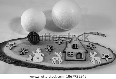 Decorative Christmas composition with a symbolic house, a snowman, animals, snowflakes and balls on a white background. Christmas Eve