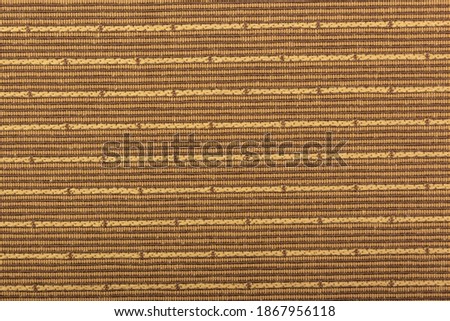 Factory fabric is brown with horizontal dotted stripes. Close-up long and wide texture of natural red fabric. Fabric texture of natural cotton or linen textile material. Red canvas background