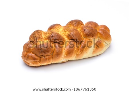 Close-up of a traditional sweet braided yeast bread called - zopf, challah, petticoat or brioche isolated on a white background (high details)