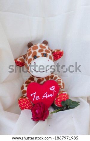 Stuffed giraffe with a red heart with the legend I love you in Spanish. Concept love, romance, engagement, Valentine. Space for writing.