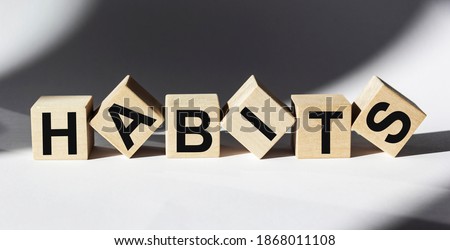 The word Habits written on wooden cubes and white background Royalty-Free Stock Photo #1868011108