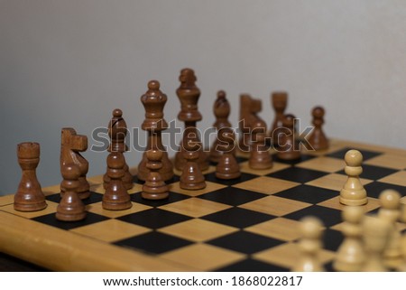 A closeup shot of brown chess pieces on a chessboard