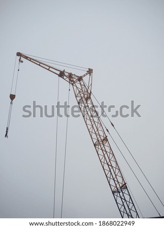 The crane works on the construction site.