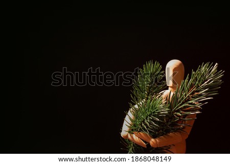 Wooden Mannequin Holding Pine Branches 