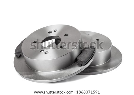 set of brake pads and brake discs new car spare parts close up isolated on a white background, brakes for a vehicle condition new, nobody.