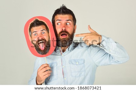 Advertising. Man holds board with face. Feeling and emotions. Face expression. Funny bearded man with cardboard in hand. Amazed man holds empty nameplate.