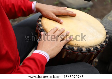 Djembe (jimbe) musical instrument percussion.
Played by hitting it with your fingers or palms Royalty-Free Stock Photo #1868090968