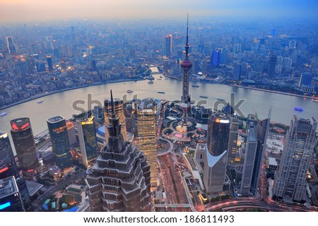 Shanghai aerial view at sunset with urban skyscrapers over river