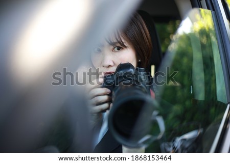 Woman taking pictures from inside the car