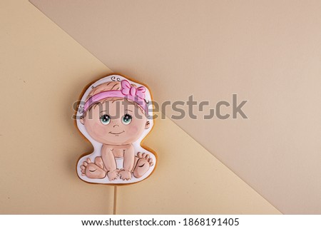 gingerbread with a picture of a baby on a beautiful pastel background. background for children's day