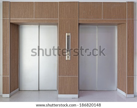 Elevator door or lift door decor by wood. Front view and interior. That is a vertical transportation machine that move people between floor, level, or deck of a building i.e. office, hotel etc.