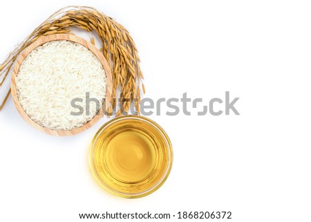 Rice bran oil extract with paddy and white rice on white background. Top view. Flat lay. Royalty-Free Stock Photo #1868206372