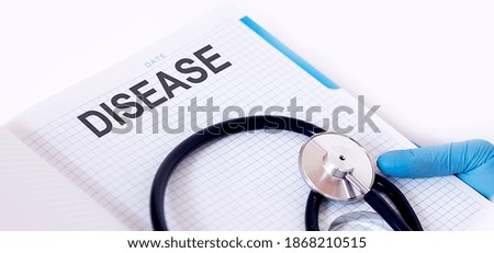 DISEASE . Notepad with text in hand of Medicine with stethoscope