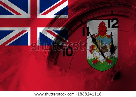 British, Britain, Bermuda flag with clock close to midnight in the background. Happy New Year concept