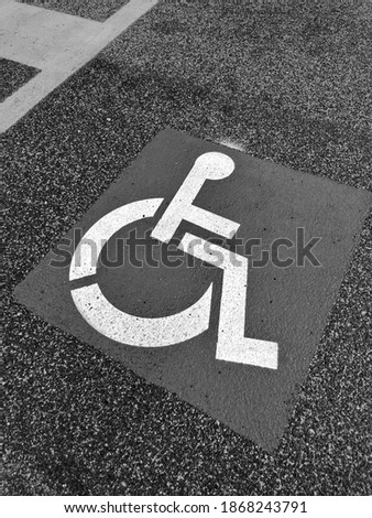 Road sign for the disabled on the asphalt of the road surface