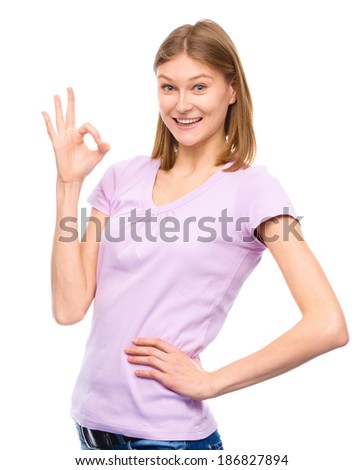 Young woman is showing OK sign, isolated over white