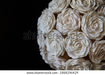 Rose flowers from paper on a black background.