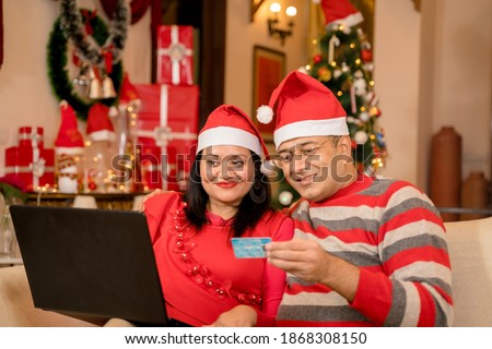 Couple at home  doing online shopping on Christmas eve