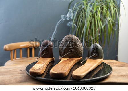 stone incense stands with smoke