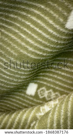 Geometric pattern on green blanket detail