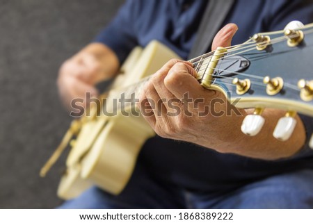Close up of playing the guitar in a music studio