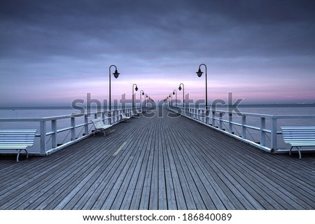 Beautiful colorful Sunrise on the pier at the seaside, Gdynia Orlowo, Poland. Long exposure photography. HDR photo