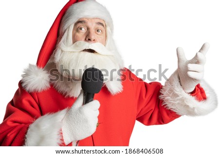 Santa Claus North pop star and celebrity singing a soulful song into a microphone. Christmas eve karaoke, on an isolated white background.