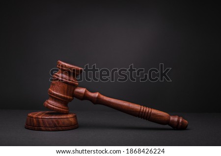 Wooden judge gavel, close-up. Court ruling. New law. The accused is guilty. Royalty-Free Stock Photo #1868426224