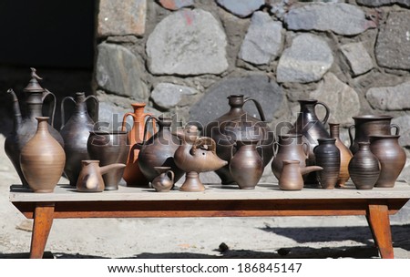 Collection of ancient clay dishes at sunny day